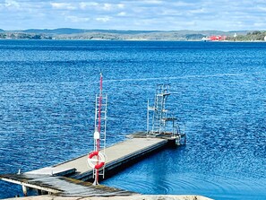 A pier extending into a body of water with a lifebuoy and a metal structure on it. - 4 Star Holiday Home in Myggenas (Myggenäs)