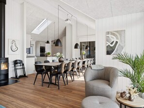 A modern interior with a dining area, kitchen, and living space.