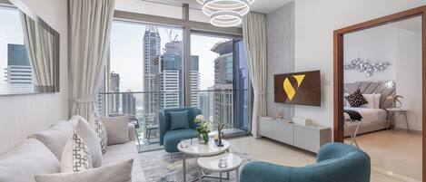 Luxury Apartment, Balcony | Living area | 65-inch Smart TV with cable channels