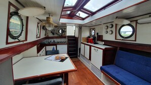 A compact kitchen with a dining area and a seating space.