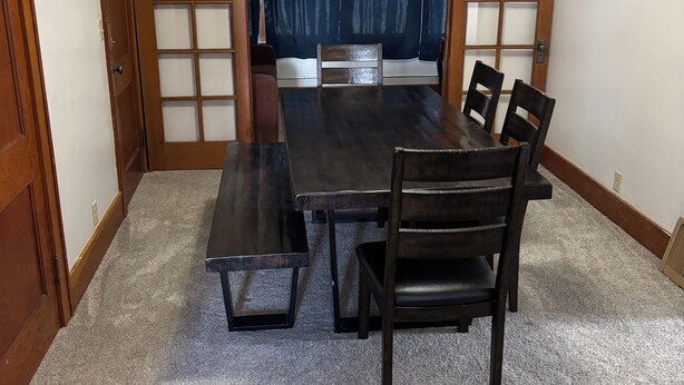 A traditional Japanese-style room with tatami mat flooring, a low table with benches, and sliding doors with frosted glass panels. - Charming 1-bedroom Duplex with AC, WiFi, Gym access etc... (Rawlins)