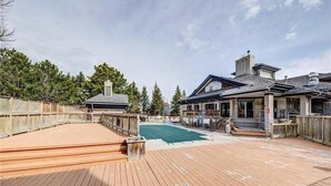 A wooden deck with a pool, surrounded by a wooden fence and trees. - Slopeside Sanctuary (Blue Mountain)