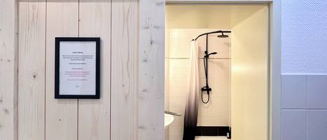 A bathroom with a shower, toilet, and sink.
