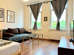 Deluxe Apartment | Living area | 30-inch flat-screen TV with cable channels