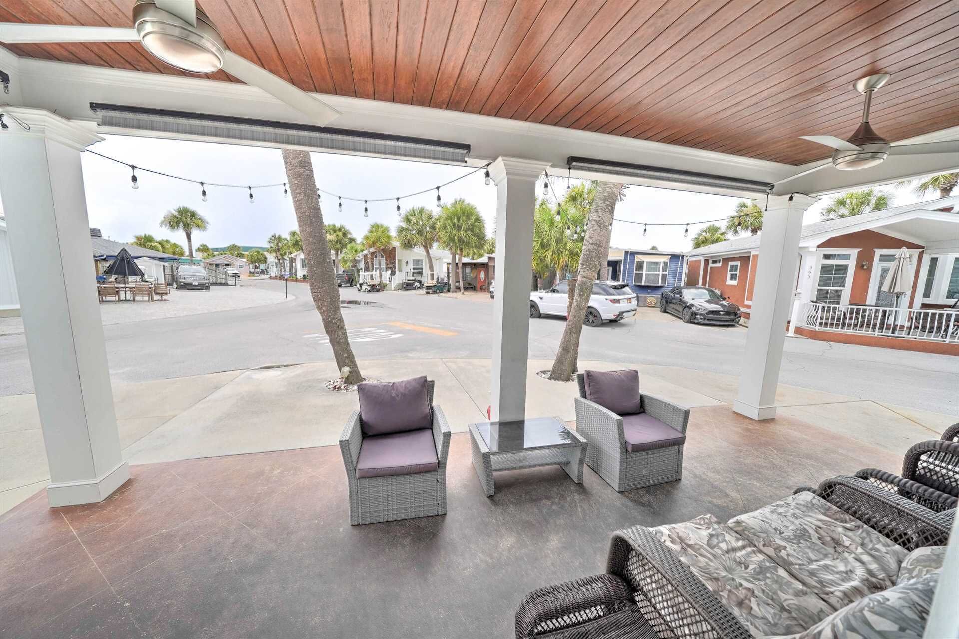 An outdoor seating area with wicker furniture and a view of the street.