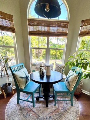 A round table with two chairs, a potted plant, and a pitcher on the table. - The Chick-Inn: Monthly Discounts, Groups, Parking! (Southport)