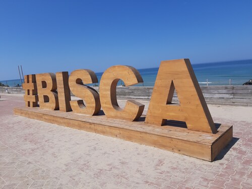 Facing the dune, a large terrace at sunset.