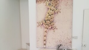 A kitchen with a sink, white cabinets, and a patterned floor. - ‘Vista Castello - Otranto’ Apartment with Sea View, Wi-Fi, and Air Conditioning (Otranto)