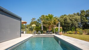 A swimming pool with lounge chairs, a pergola, and palm trees. - Studio Apartment '890' with Private Terrace, Wi-Fi and Air Conditioning (Lorgues)