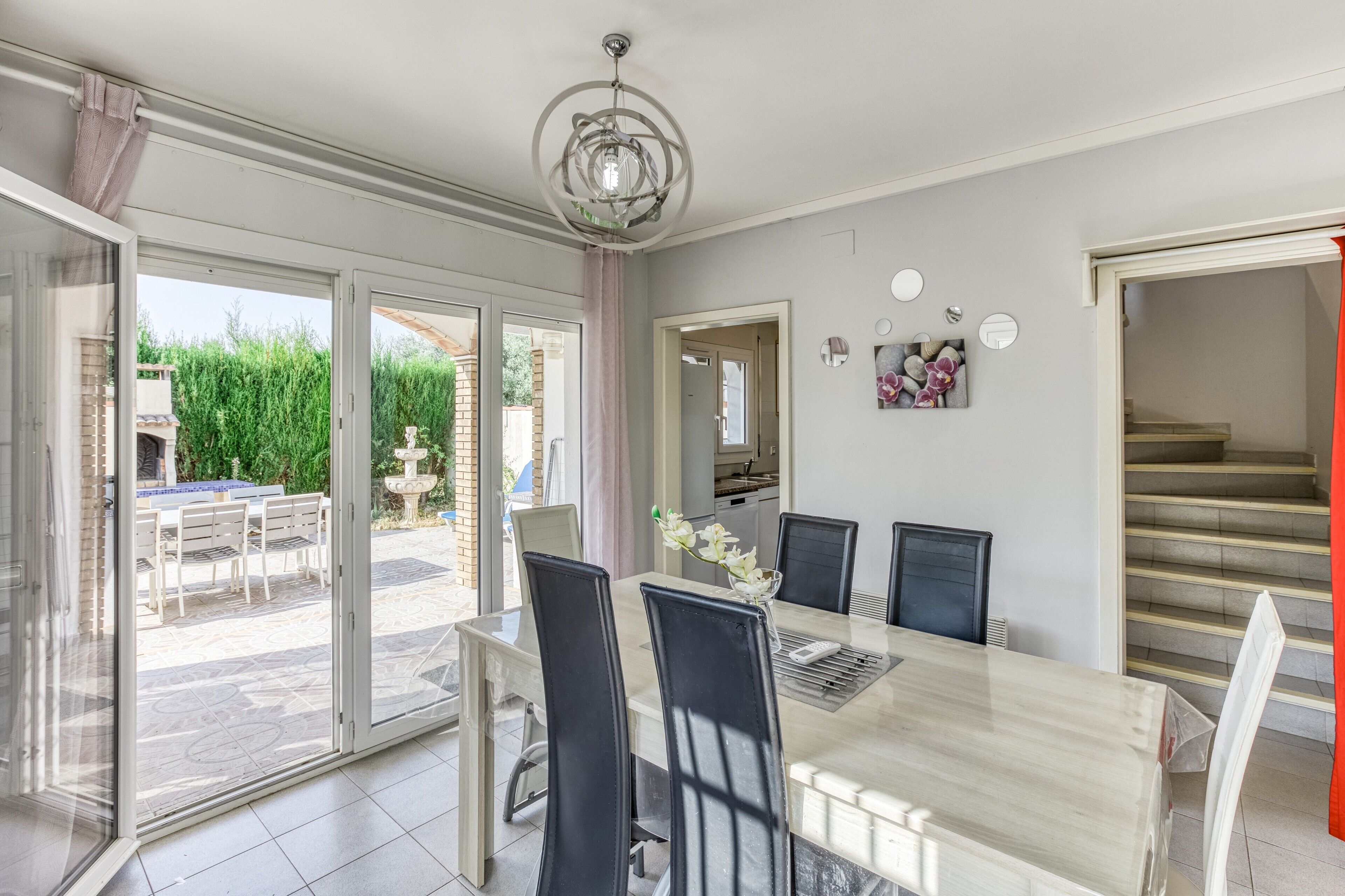 A dining area with a table, chairs, and a view of the outside.