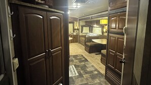 A compact, well-lit room with a kitchenette, a sofa, and a dining area. - Cozy RV in charming McClure with AC, WiFi. Happy travels (McClure)