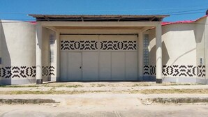 Un bâtiment doté d’un grand portail de garage, de murs à motifs et d’un sol en béton.
