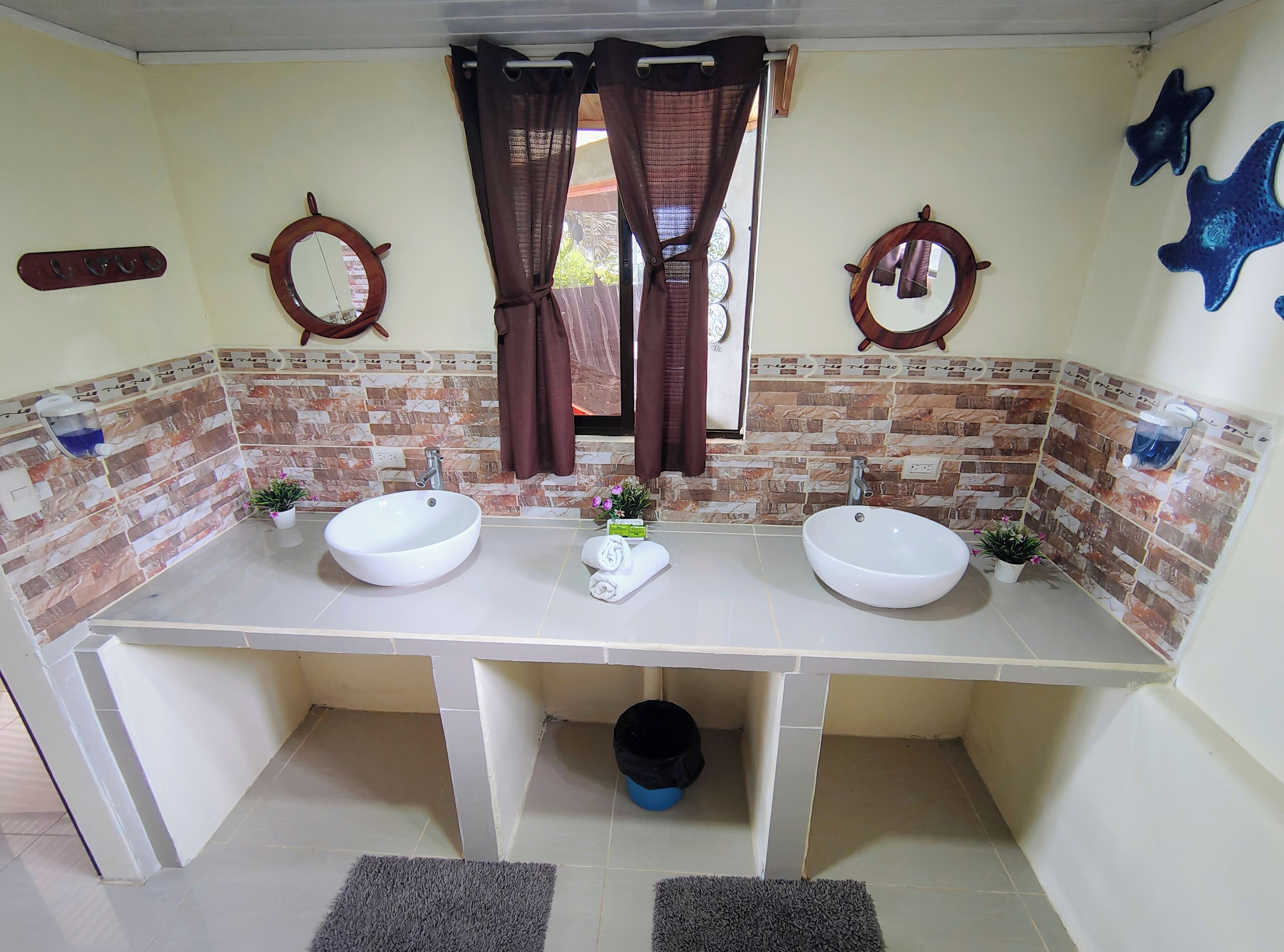 A bathroom with two sinks, a mirror, and a shower curtain.