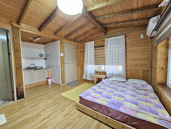 L’intérieur d’une cabane en bois comprend un lit, une petite cuisine et une salle de bain.