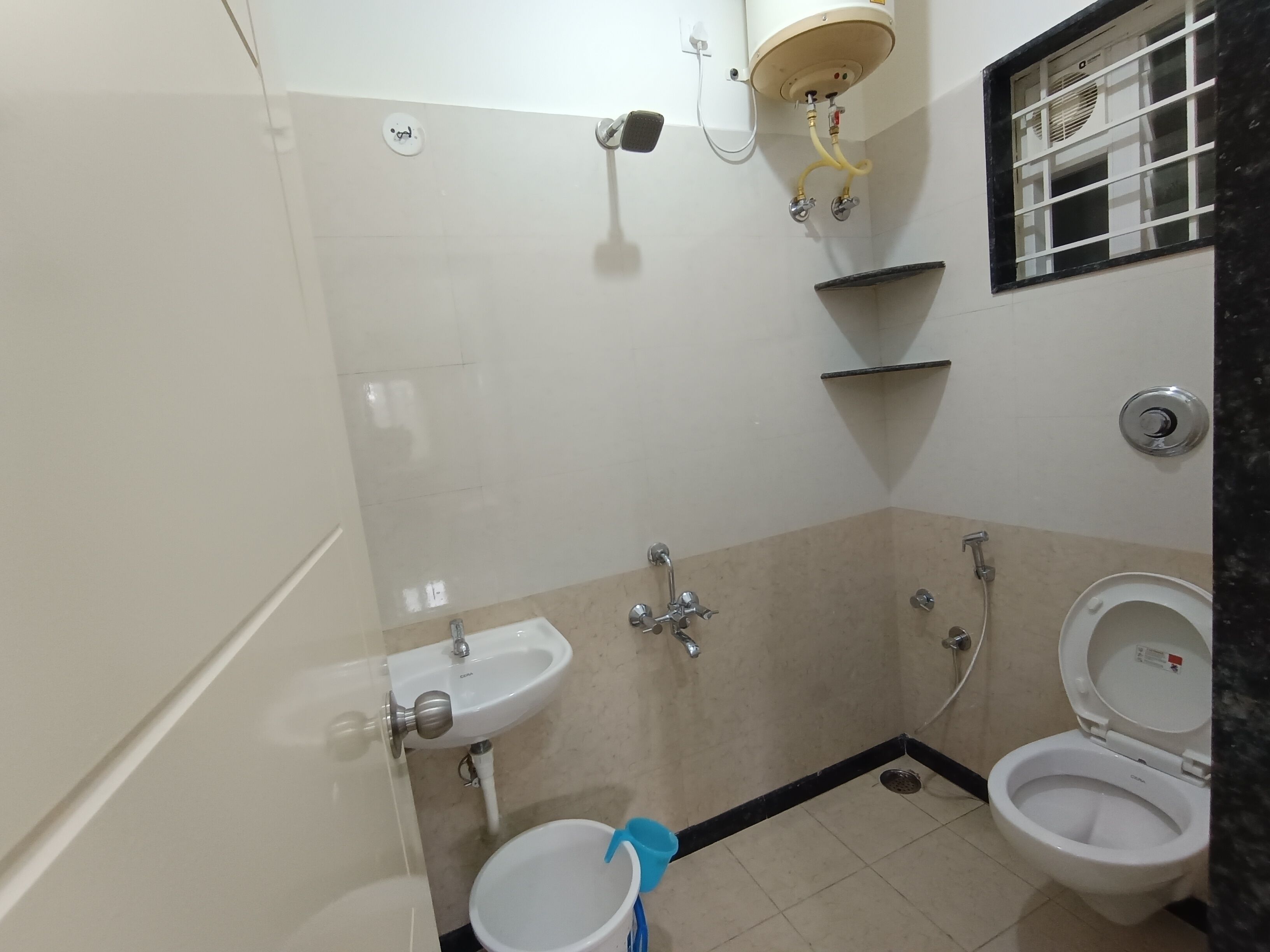 A small bathroom with a sink, toilet, and shower.