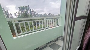 A balcony with a checkered floor and a white railing. - SAGAR NIWAS SARJAPUR (Bengaluru)