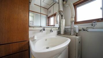 Combined shower/tub, free toiletries, hair dryer, slippers