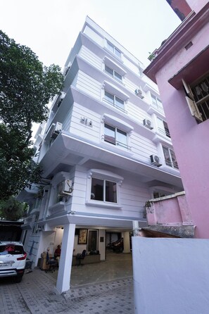 A multi-story building with a white facade, multiple balconies, and air conditioning units. - Victoria Apartment by Jadecaps (Kolkata)