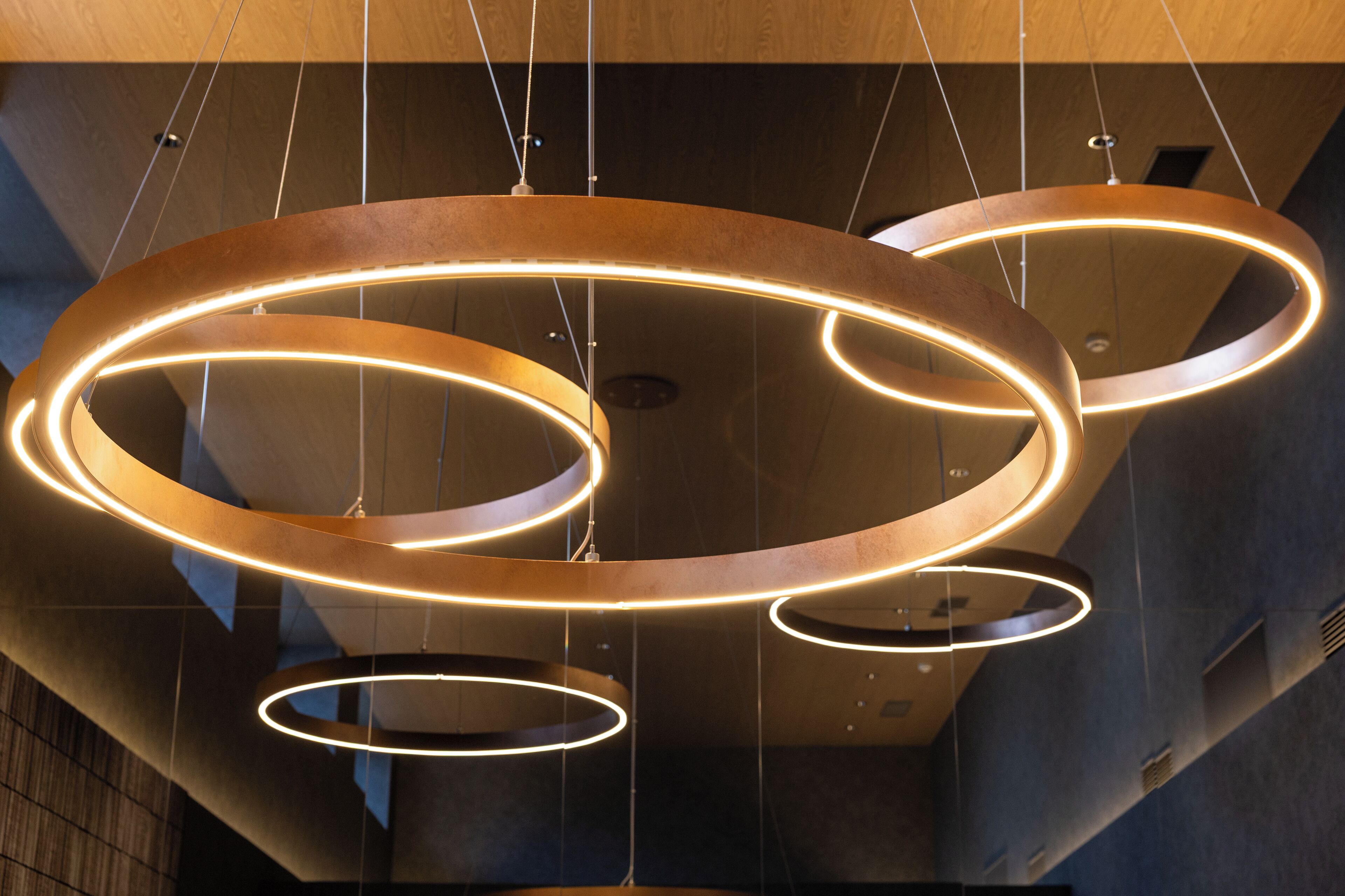 A modern interior with a circular, multi-tiered light fixture.