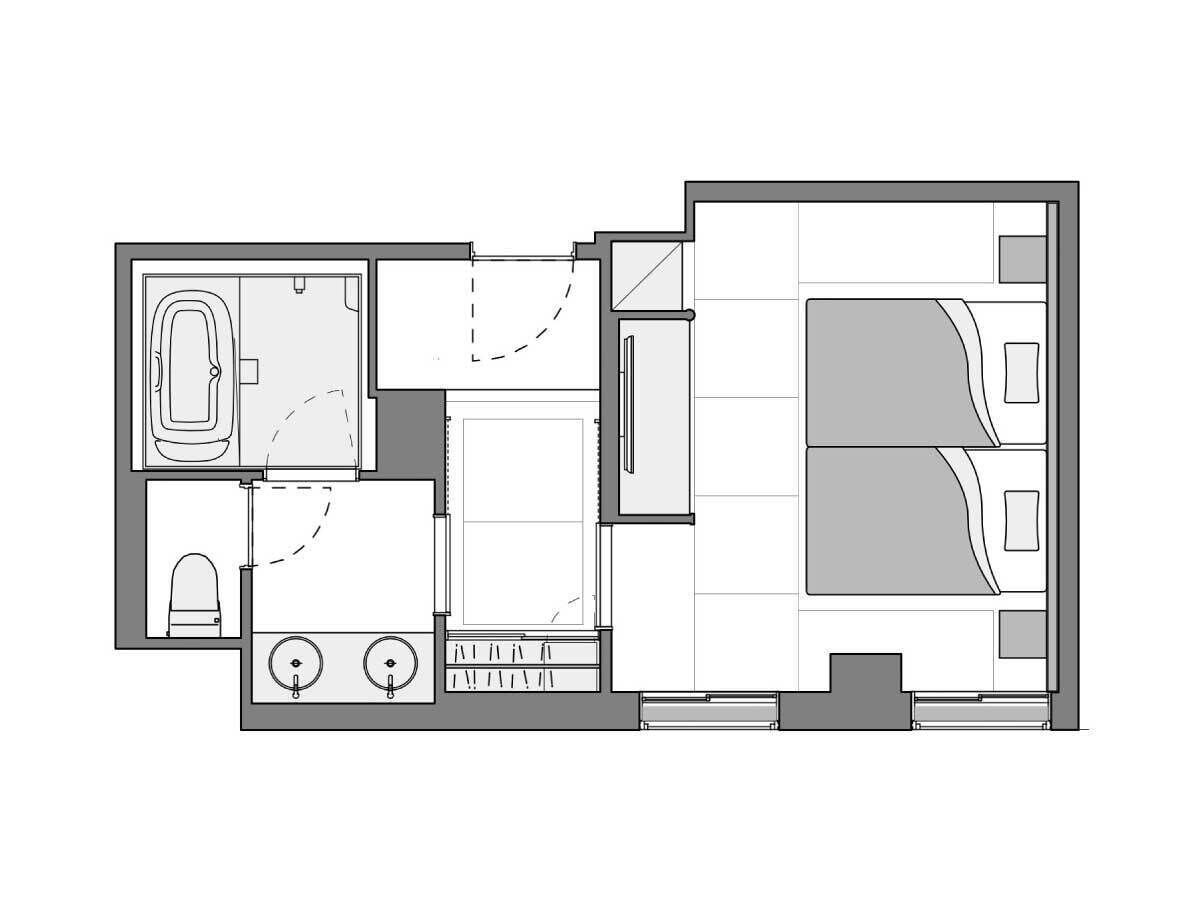 A floor plan of a hotel room with a bathroom, a kitchenette, a seating area, and a bed.