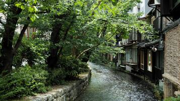 A narrow waterway flanked by traditional buildings with wooden facades and tiled roofs.