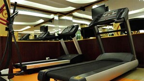 A gym with treadmills and exercise equipment. - Westlands Gardens Apartment (Nairobi)
