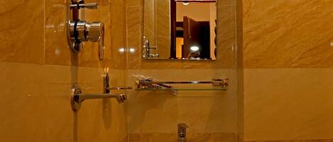 A bathroom with a sink, mirror, and towel rack.