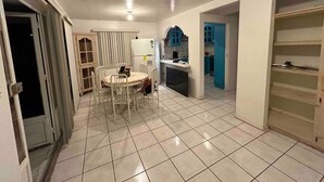 A spacious kitchen with a dining area, a refrigerator, and cabinets. - Charming 4-bedroom house with WiFi in Playas de Rosarito, secure gated parking (Playas de Rosarito)
