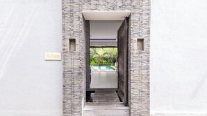 A narrow entrance to Villa Naema with a sign, leading to a pool area. - Villa Naema - 4 BR Private Villa (Seminyak)