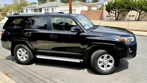 A black SUV parked on a street.
