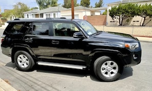 A black SUV parked on a street.