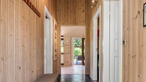 A wooden interior hallway with a bench, a door, and a view into another room. - "Rosaline" - 500m from the sea by Interhome (Grenaa)