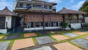 A two-story building with a 'WELCOME' sign in front. - THE LIGHT VILLA (Trou d'Eau Douce)