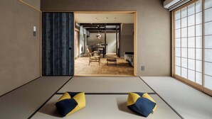 A tatami mat room with a sliding door leading to a dining area. - Waren Bettei Machiya House (Kyoto)