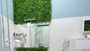 A modern bathroom with a white sink, vanity, and bidet. - Tropical style suite (Licata)