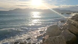 A coastal scene with rocky terrain and the ocean.