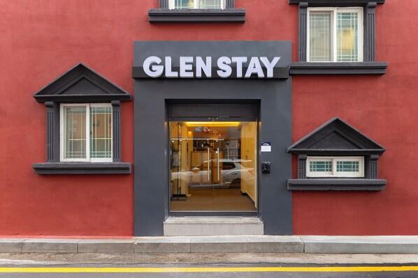 The exterior of a hotel named GLENSTAY with a modern design, featuring a prominent entrance and two small windows on either side. - Glen Stay Dongducheon (Dongducheon)