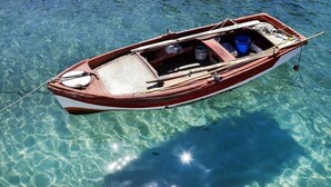 A small wooden boat floating on clear water.