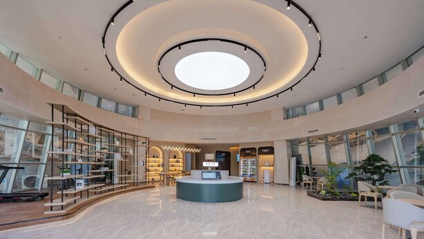 A spacious lobby with a central reception desk, glass walls, and a circular ceiling design. - Tingxi Hotel Science Avenue Subway  (Hefei)