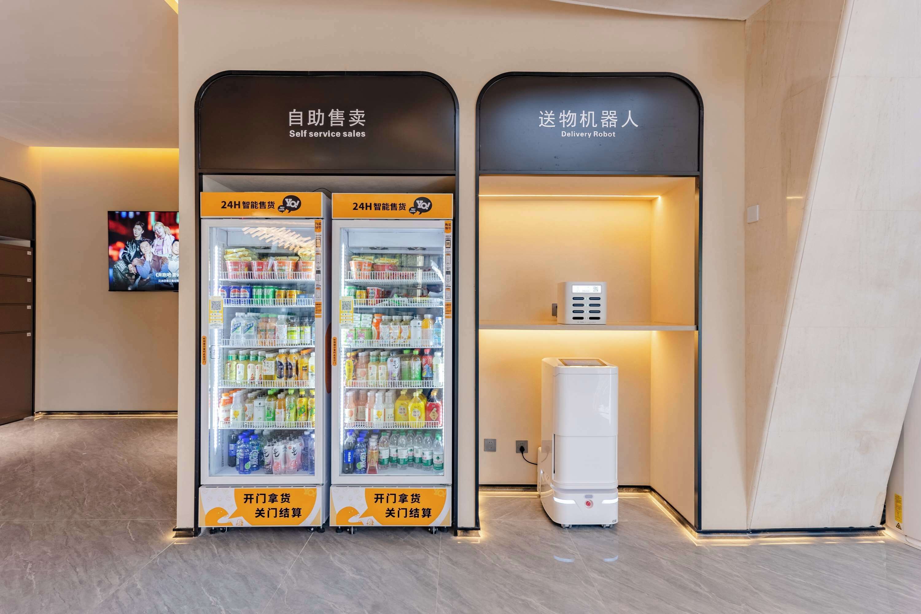 A self-service vending machine area with two vending machines and a delivery robot.
