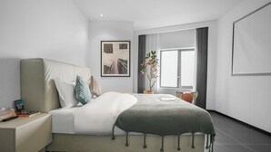 A modern bedroom with a large bed, a bedside table, a potted plant, and a window with curtains. - Time Wharf Hotel - Jiefangbei Shibati (Chongqing)