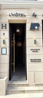 The entrance to L'Hôtel by the Boutique Hotel, featuring a reception area and a staircase leading inside.