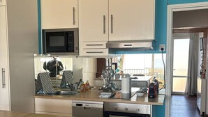 A compact kitchen with a microwave, oven, and dishwasher. - Beautiful 2-Room with WIFI, AC - Pets Allowed (Canet-en-Roussillon)