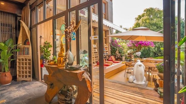 A wooden deck with outdoor furniture and decorative items.