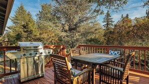 A wooden deck with a grill and outdoor furniture. - Family-Friendly 5BR Retreat – Hot Tub & Game Room (Gresham)