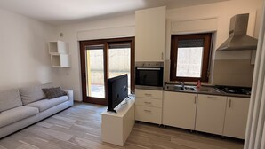 A modern kitchen with a built-in oven, a flat-screen TV, and a sink. - Oasi Perugina - maximum comfort in the beating heart of Perugia (Perugia)
