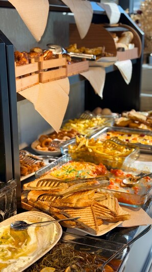 Un bufé con diversos alimentos y utensilios.