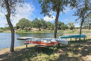 A lakeside setting with canoes and a dock.