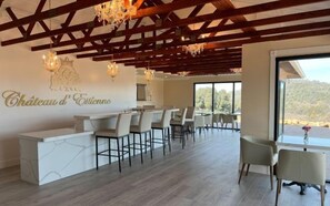 A reception area with a bar, seating, and a view of the outdoors. - Lakefront Haven+GameRoom+Canoe with Stunning Views (Somerset)