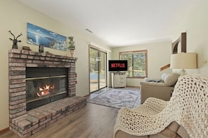 A living room with a fireplace, a television, and a couch.